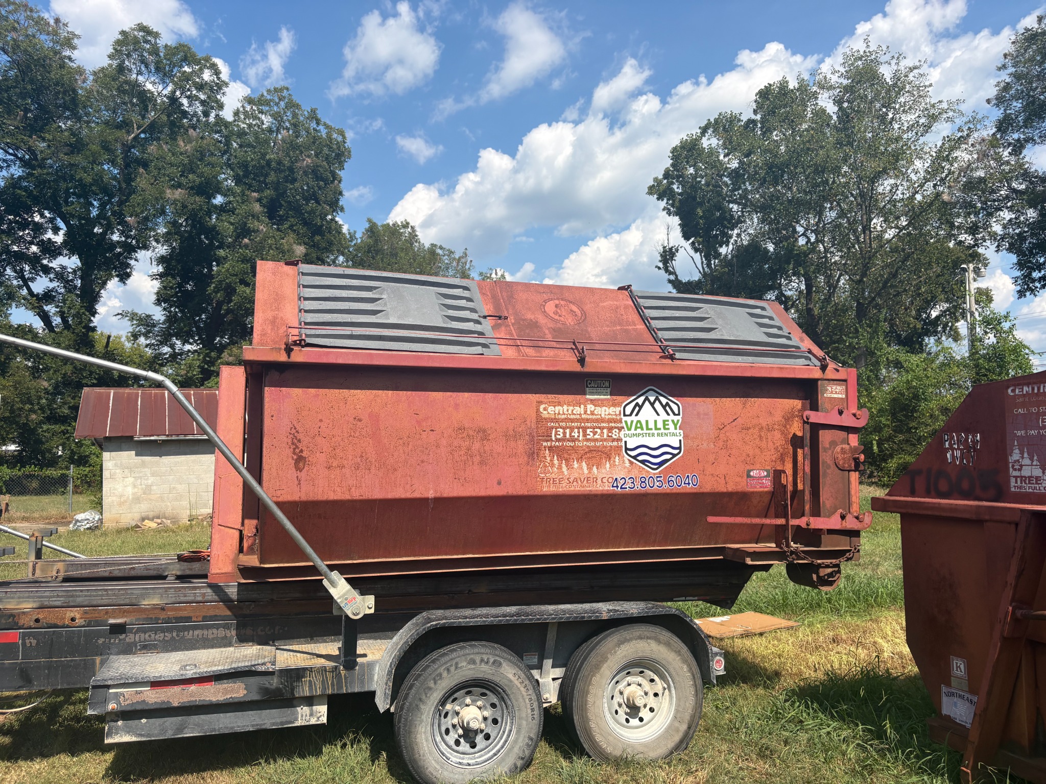 Valley Dumpster Rentals red enclosed closed-top dumpster on trailer